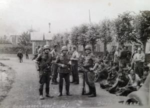 Captured soldiers awaiting transhipment to prisoner of war camps. Courtesy of Ron Akines