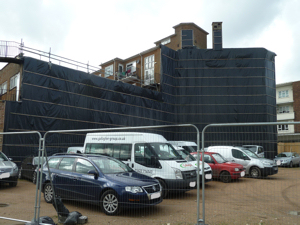 The former Granada cinema site, Castle Street, now a car park for workers on the St James development. Note the black polythene protecting adjacent buildings that has been there since the cinema was demolished in 2014. AS March 2017