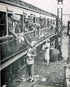Dunkirk Troops being given food and drink enroute by train out of Dover - tired but cheerful. Doyle Collection