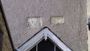 Fleur de Lis Plaques, above door of the Torchlight Homeless Drop in Centre, Church Street. One had R and B inscribed the other appears to E and R inscribed. Alan Sencicle 2009