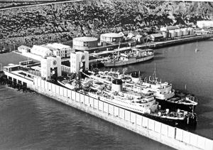Ariel cable ship in the Camber 1959 in front of the two oil tanks the offices are to the left. The two cross Channel ships are Maid of Kent nearest the quay and the Lord Warden on the outside. Dover Harbour Board