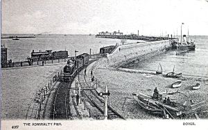 Admiralty Pier during the construction of the extension with the former SER railway line going west and the former LCDR line going north. A steamer can be seen tied up against the outside of the Pier and boat builders on Shakespeare Beach Dover Library 