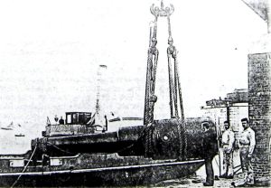Admiralty Pier - The landing of the 80-ton gun on to the trunnion tray December 1881.