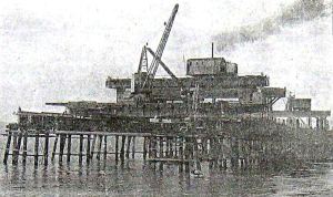 Huon pine staging posts across which a lattice of steel girders were bolted and on these, heavy timber platforms were laid.