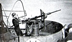 Prince of Wales Pier Gunner in World War II manning Oerlikon gun against attack. Doyle Collection