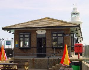 Prince of Wales Pier Lighthouse tea room with lighthouse behind. Alan Sencicle