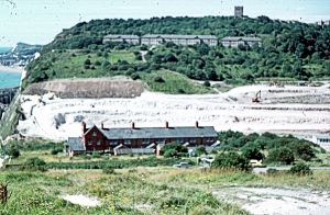 East Arrow Block just below the Castle and demolished in 1984. The photograph shows the excavation of the A2 Jubilee Way in the 1970s. Dover Museum