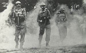Home Guard in a mock gas attack and wearing gas masks during a training session. Doyle Collection