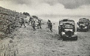 Royal Army Service Corps and members of the Home Guard searching the vegetation along a Southern English beach for enemy paratroops - government leaflet. Doyle Collection