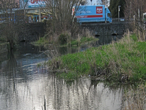 Bridge over the Dour at Charlton Green with three arches. Through the left arch the diverted stream joins the main river. LS