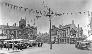 EKRCC buses lines up in Market Square circa 1935 and note the EKRCC office sign on one of the buildings on the left - west side of Market Square. Bob Hollingsbee Collection, Dover Museum