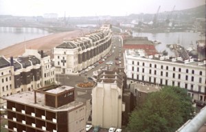 Near to camera is the Dover Stage Hotel. Facing is Cambridge Terrace with Granville Gardens in between. Waterloo Crescent is facing the sea and Wellington Dock is to the right at the rear of Cambridge Terrace. In between the Dock and Waterloo Mansions is Cambridge Road. The photograph was taken from Burlington House in 1974. Dover Museum