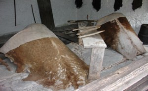 Hides being soaked before removing the hairs using the tools. St. Fagans, National Museum Wales Cardiff. Zurek