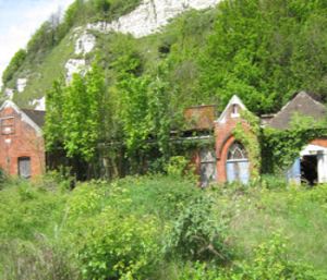Old Territorial Army buildings below Mote Bulwark on Townwall Street. Since demolished but the site remains overgrown and derelict. Lorraine Sencicle