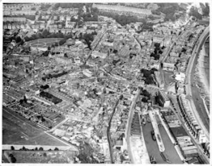 Aerial view of central Dover in the 1930s Pencester Gardens is easily identifiable as the open space in the top left quadrant with circular and cross footpaths the Stembrook area is on the sea side. Dover Museum