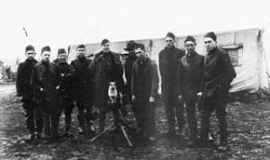28th Aero Squadron NCOs 18.11.1918 Foucaucourt Airodrome, France with camp mascot dog on a machine gun. Air Service, United States Army